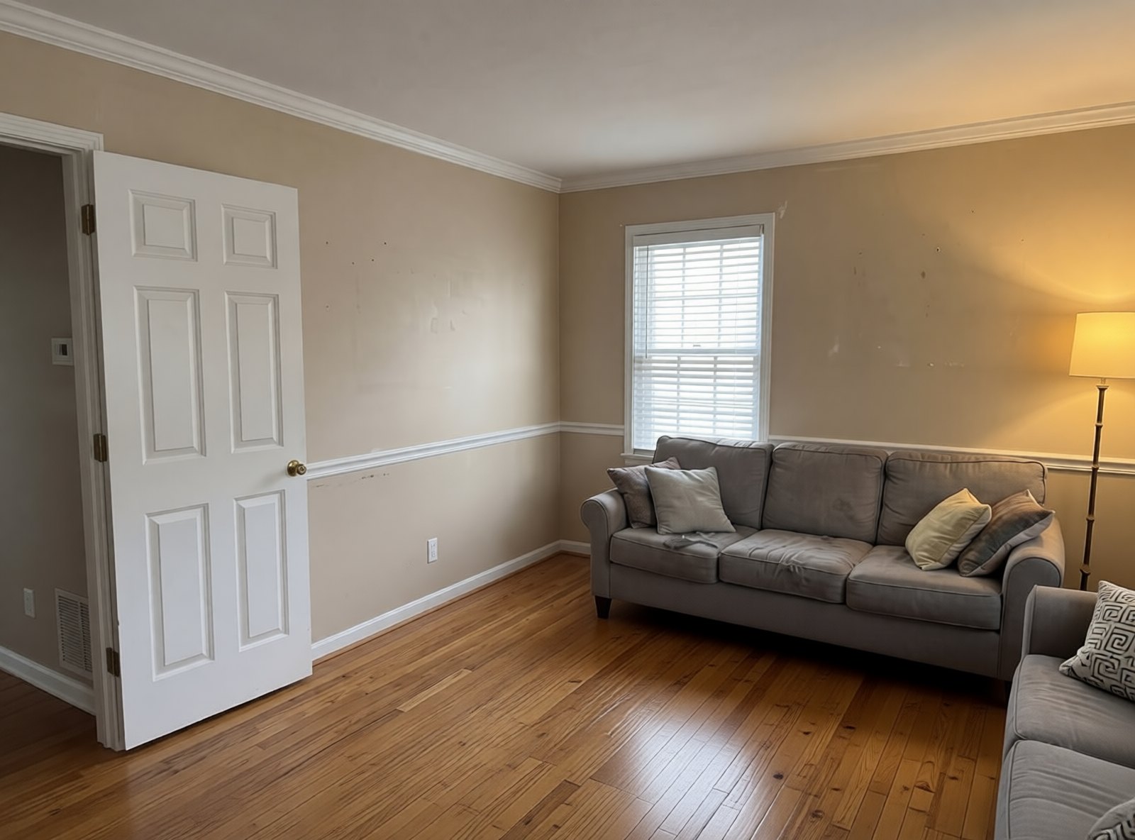 Living room before: original hardwood with an area rug